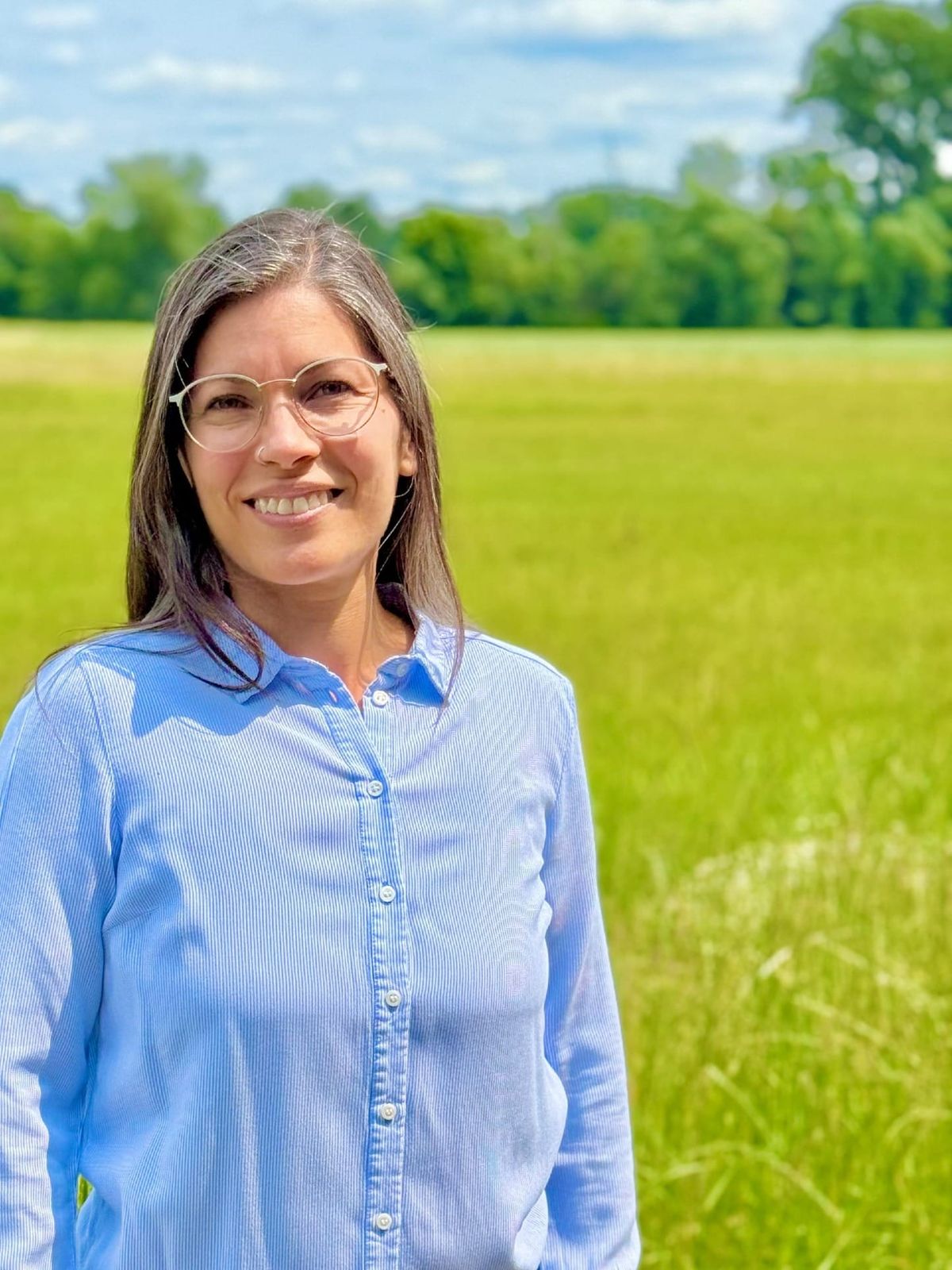 Woman standing infront of a field