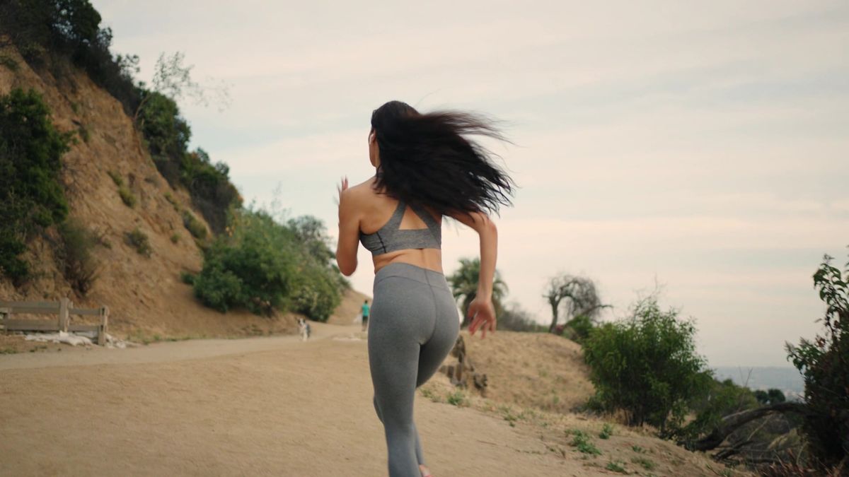 woman running outside, exploring the benefits of running and sprinting backed by science.