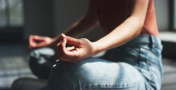 woman meditating, natural remedies for daily stress relief.