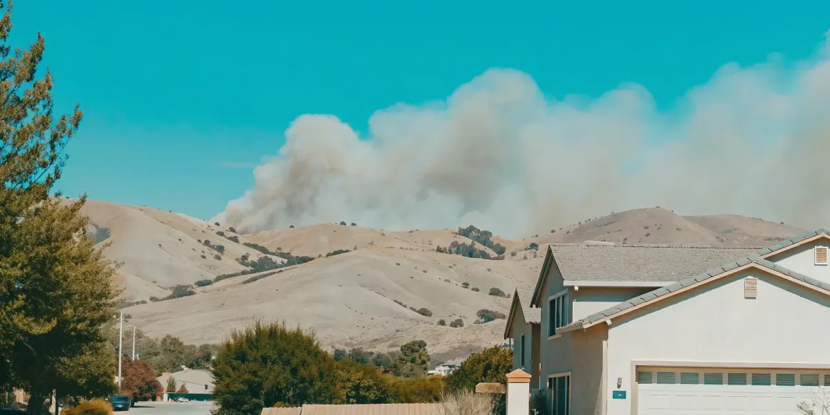 A Northern California property under threat from a wildfire, a key factor in risk evaluation.