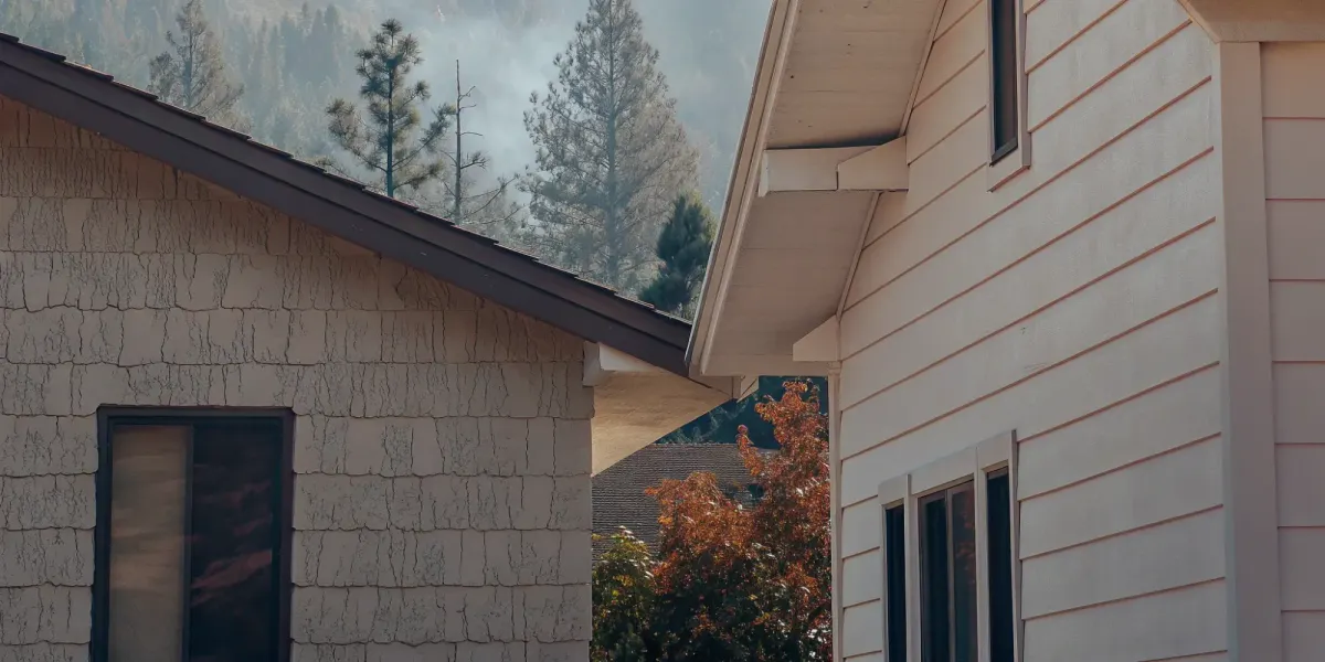 Fire-resistant fiber cement siding vs stucco on homes in a wildfire-prone area.