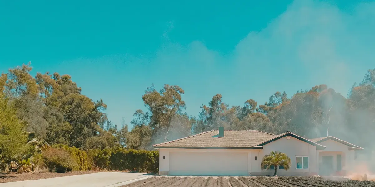 A fire break of cleared land around a house to stop a wildfire.