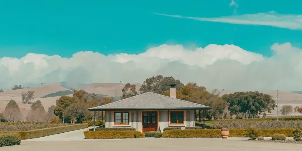 A home showing how to create defensible space with a cleared yard and trimmed landscaping.