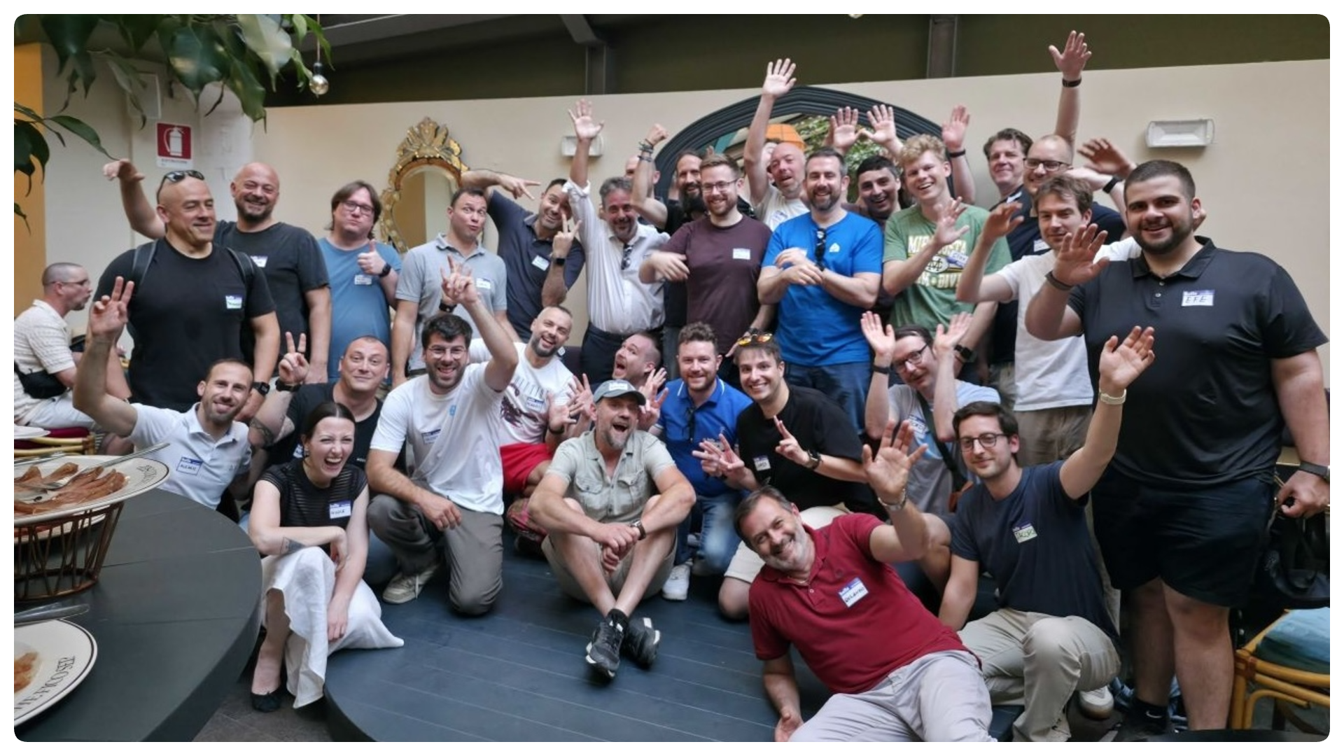 A group of people smiling and cheering at the camera at the Nabu Casa Home Assistant meetup in Rome.