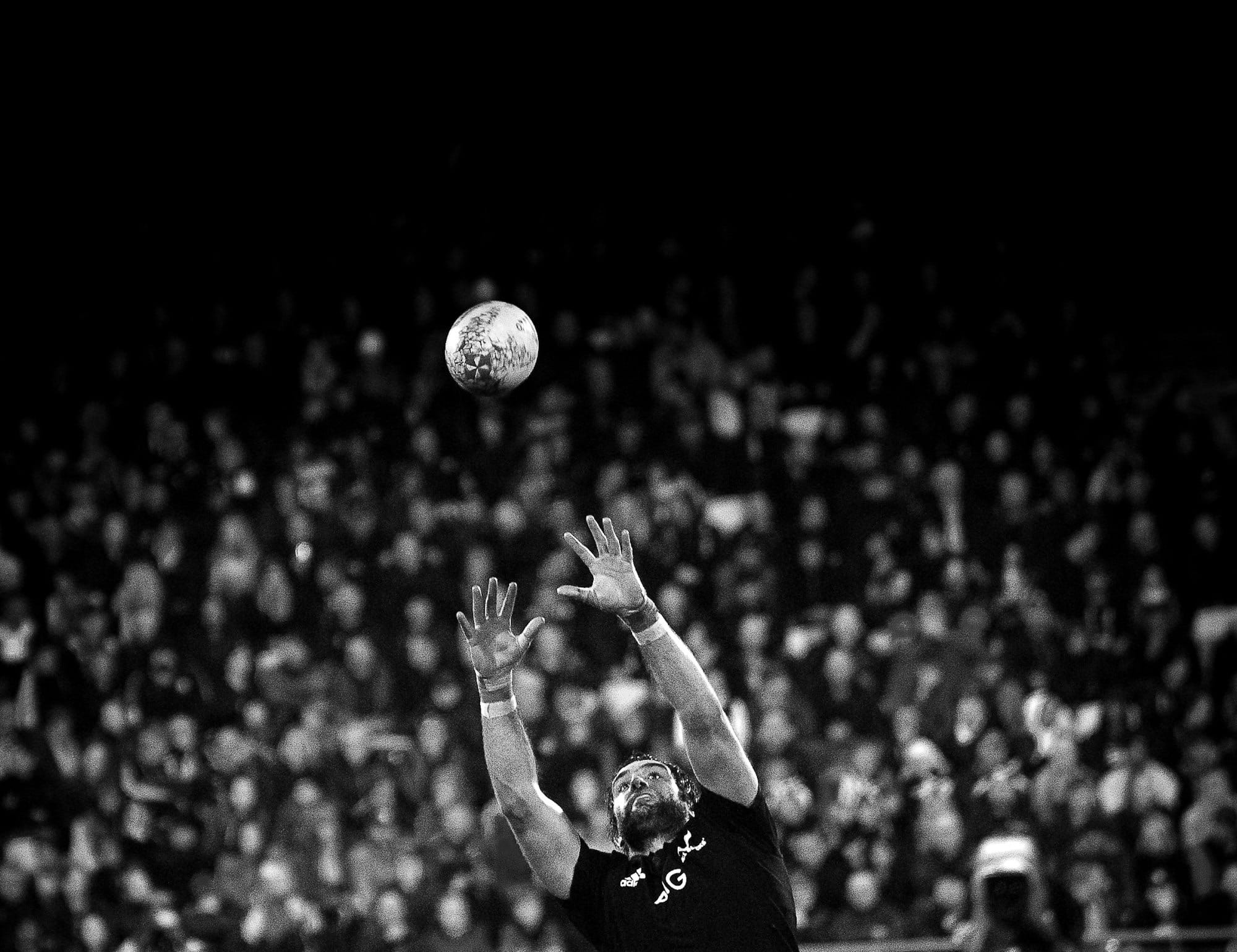 grayscale photo of NFL player catching ball