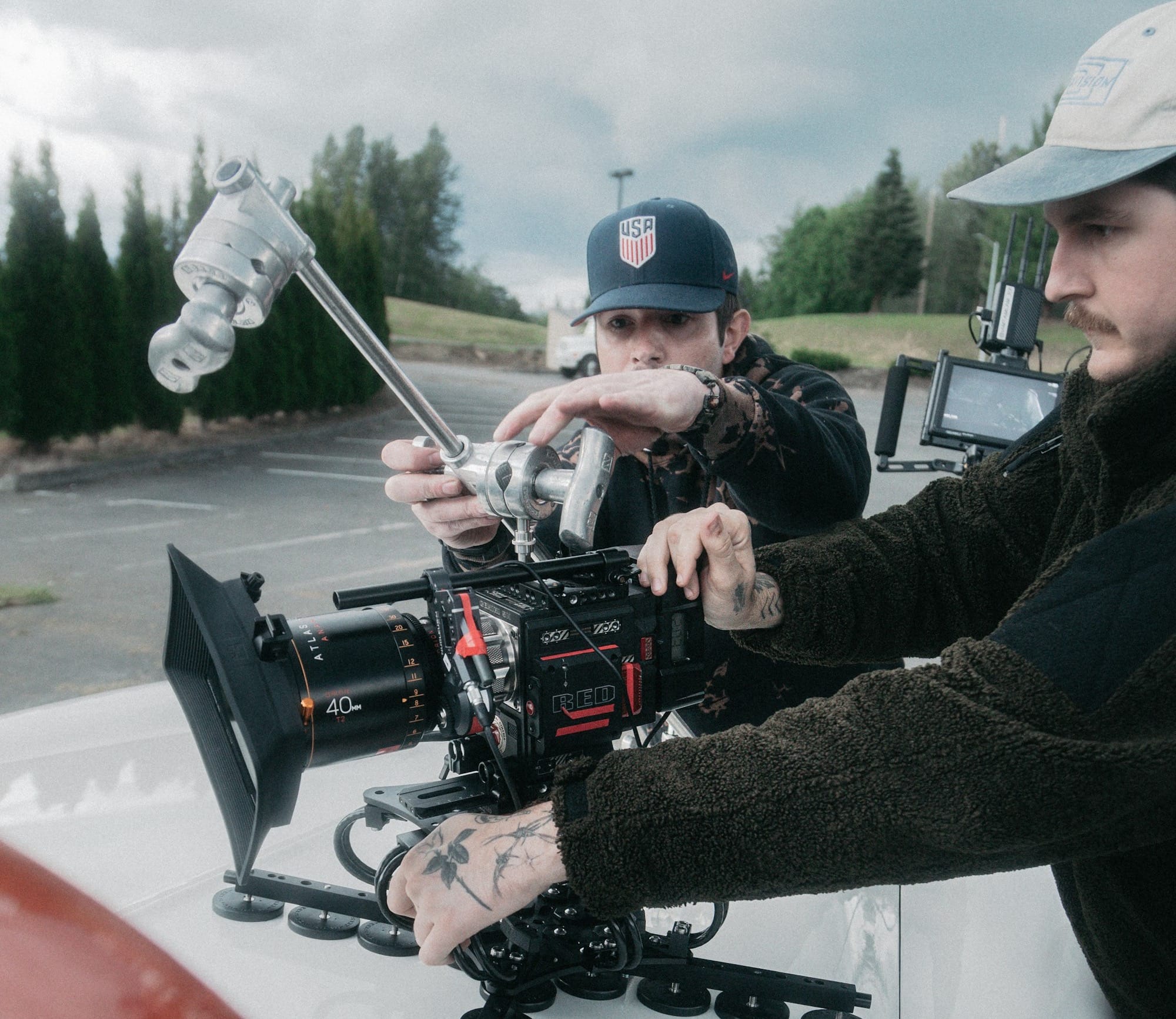 man in black jacket holding black video camera