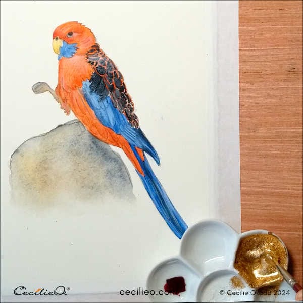 Mixing watercolor gold to use in the painting.