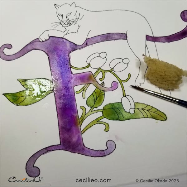 Adding greeen watercolor to the illuminated letter F.
