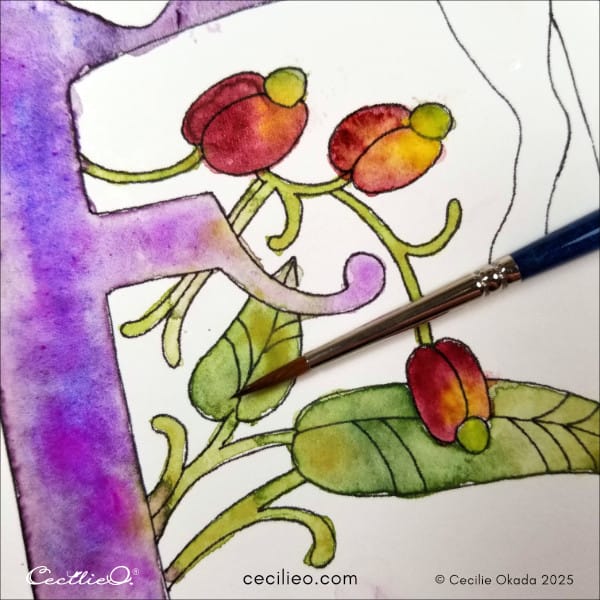 Painting the red berries on the letter F.