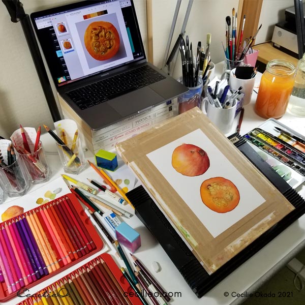 Tilted drawing board on a messy art desk.