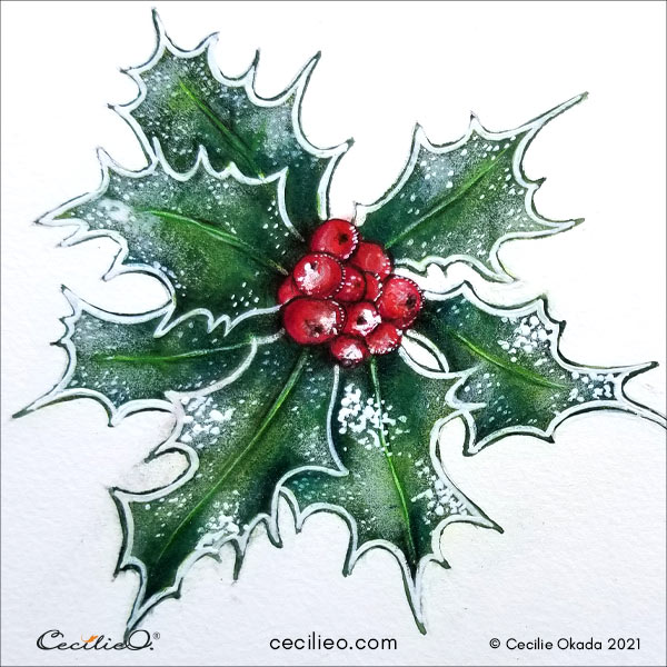 The completed holly with snow and shiny leaves.