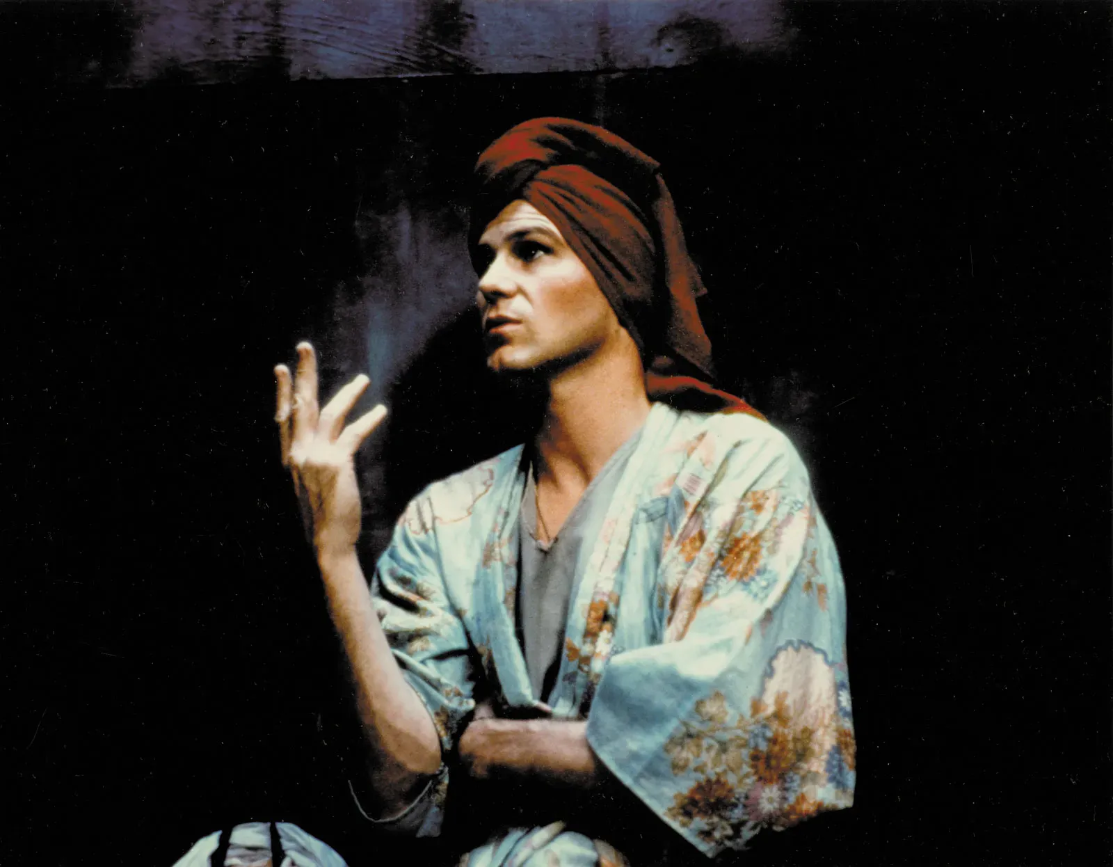 A person in a kimono with a towel covering their wet hair gestures dramatically while gazing into the void.