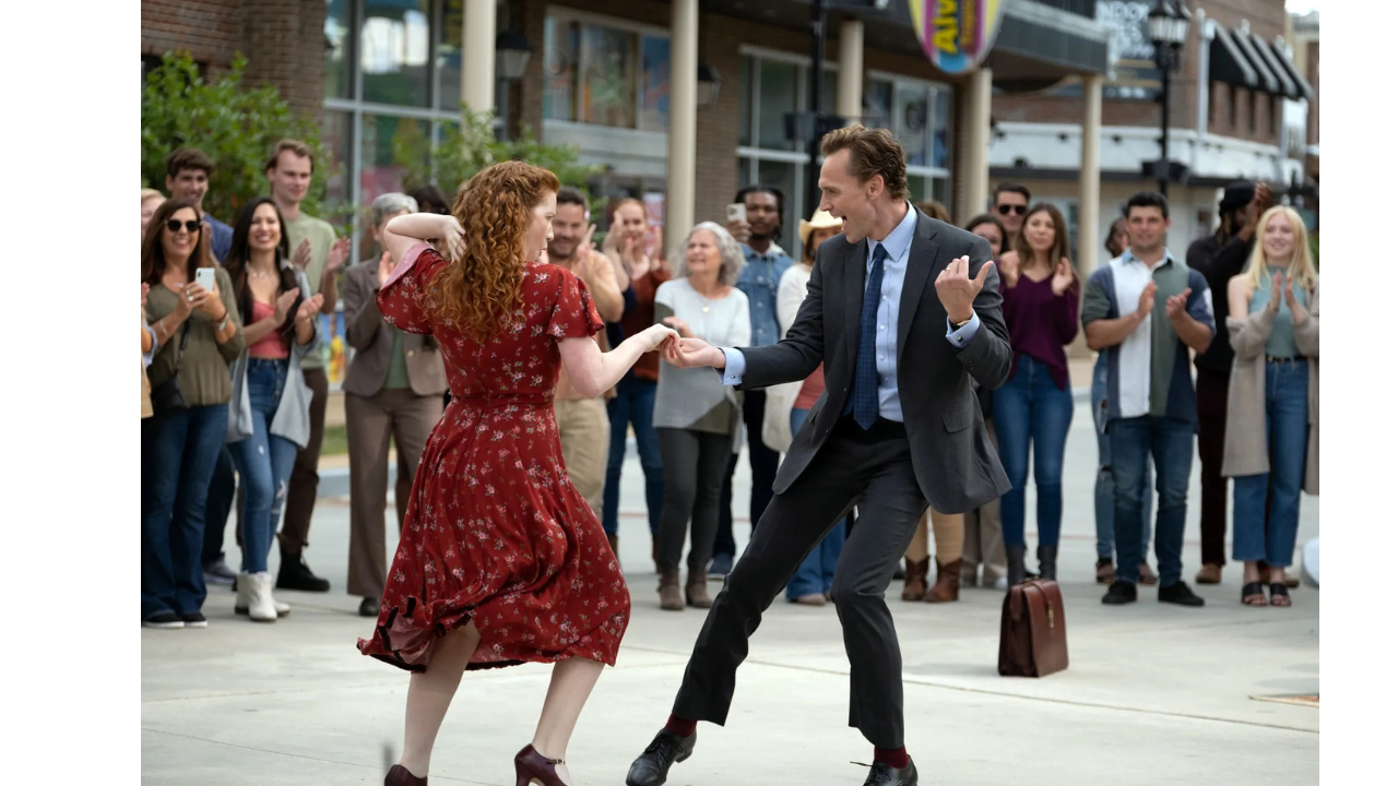 The same image of Tom Hiddleston and Annalise Basso dancing, with a delighted crowd looking on in the background.