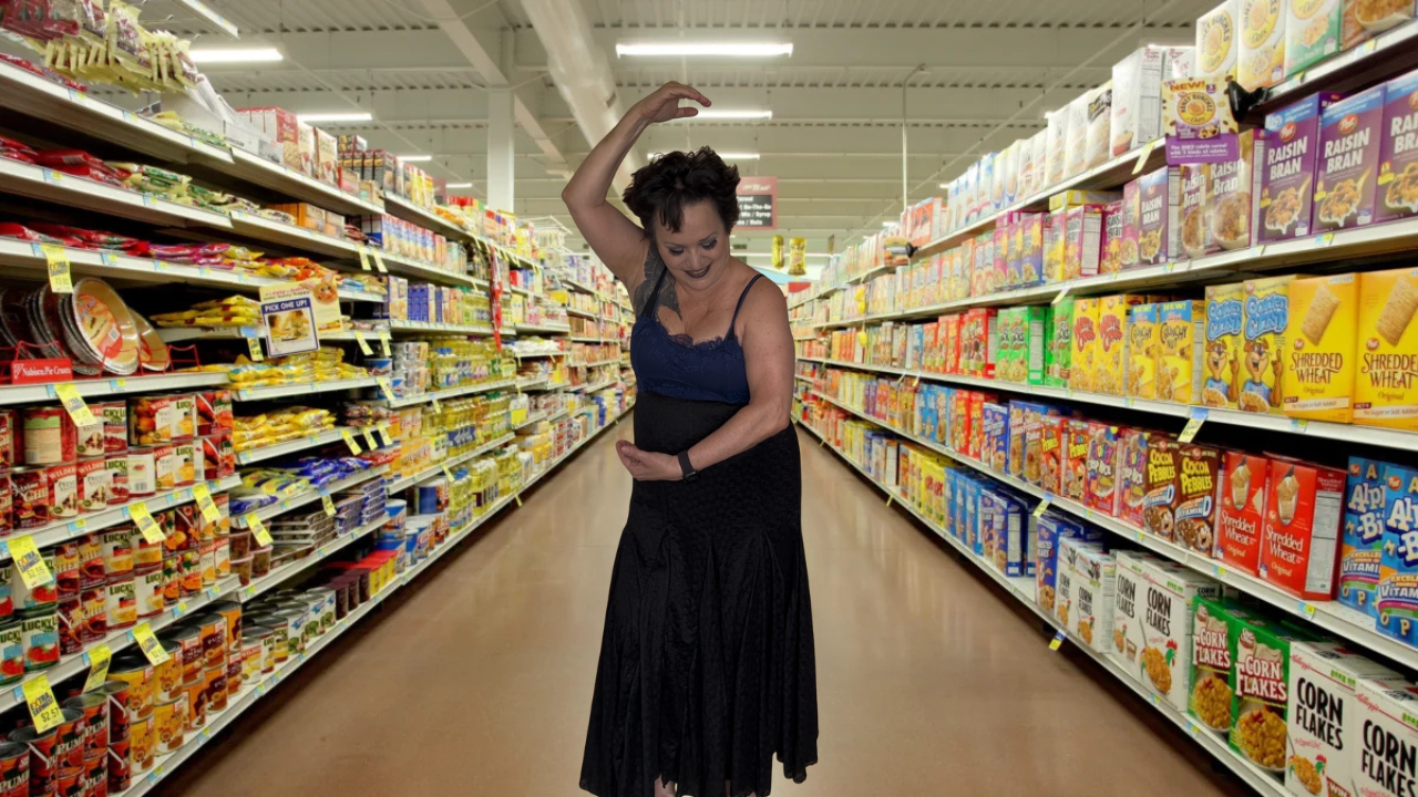 Me doing the Safety Dance in a grocery store, making an S with my arms.