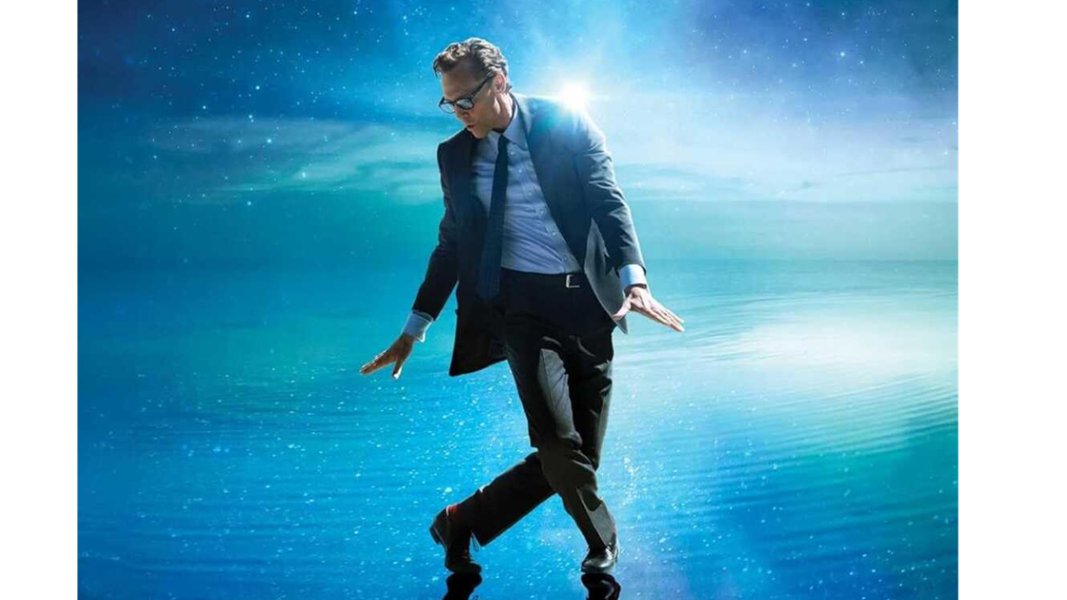 Tom Hiddleston dancing against a starry blue background. 