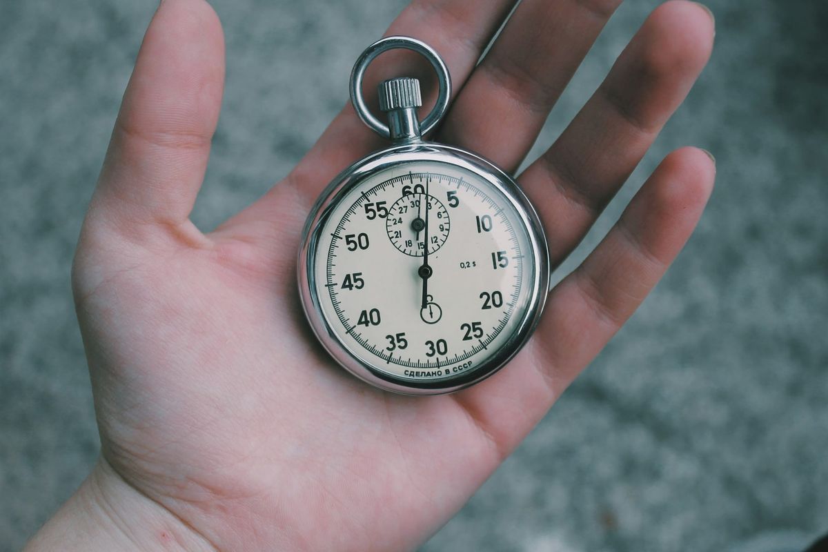 Man Holding Clock - Any.do vs Todoist