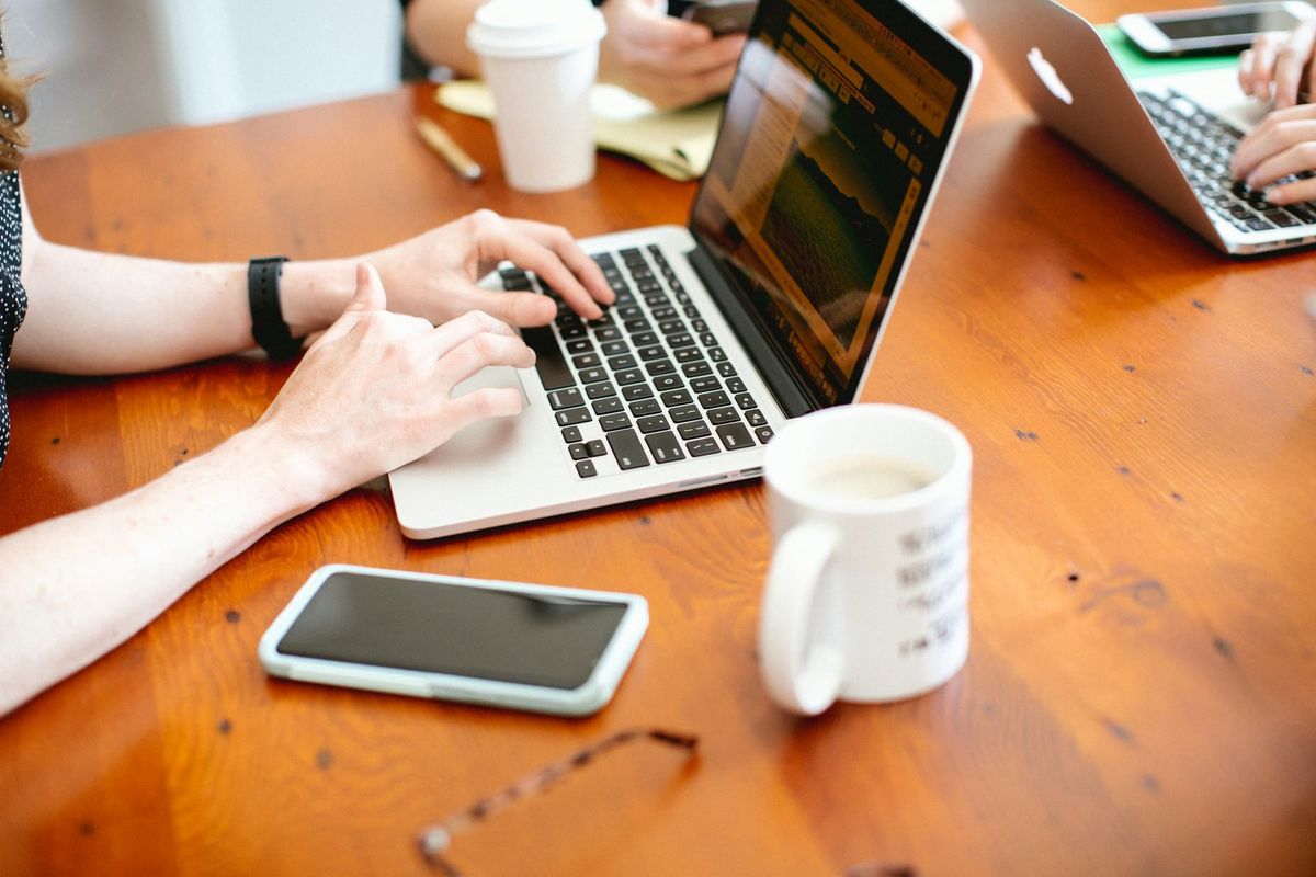 woman typing on a laptop - Best Note-Taking App for Coding 
