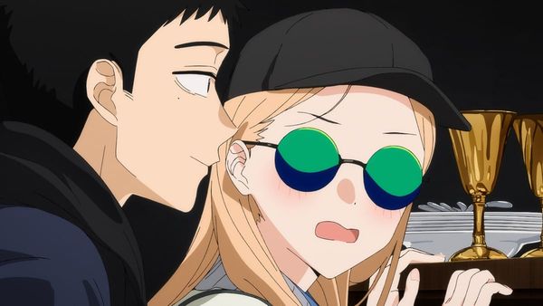 Kitigawa blushes with a scared expression while Gojou stands just behind her with a smile.