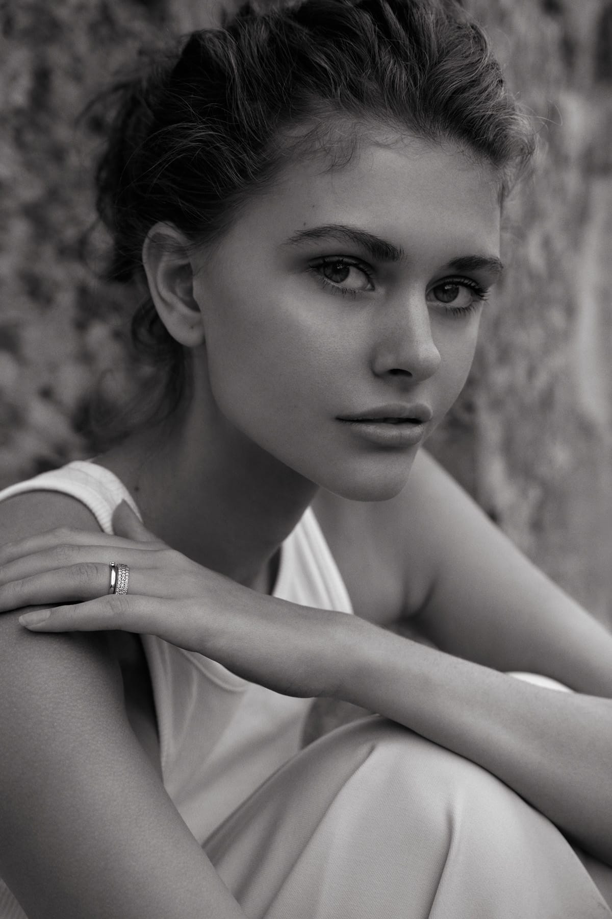Close portrait of Alyona Lihosherstowa with hair pulled up, arms folded across her knees, photographed by Alexei Bazdarev.