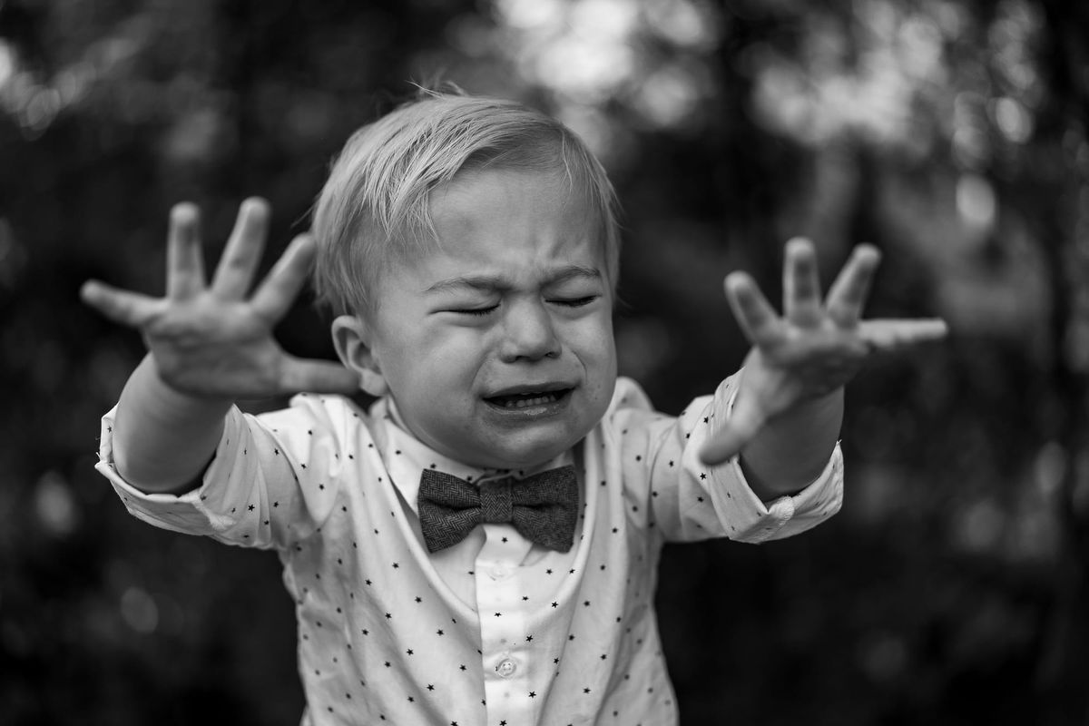 Upset baby wearing a tie