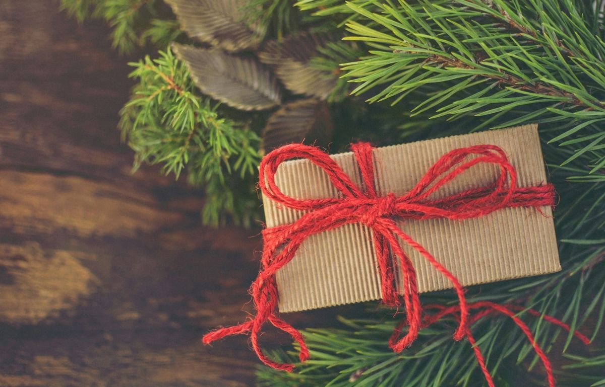 gift wrapped in brown paper with a red bow