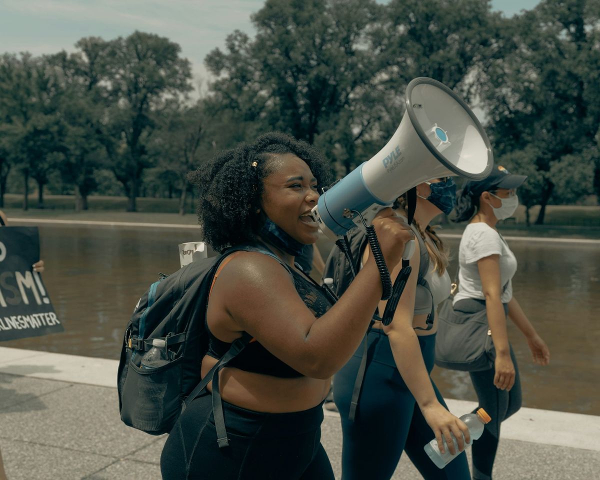 Young woman with a megaphone at a protest