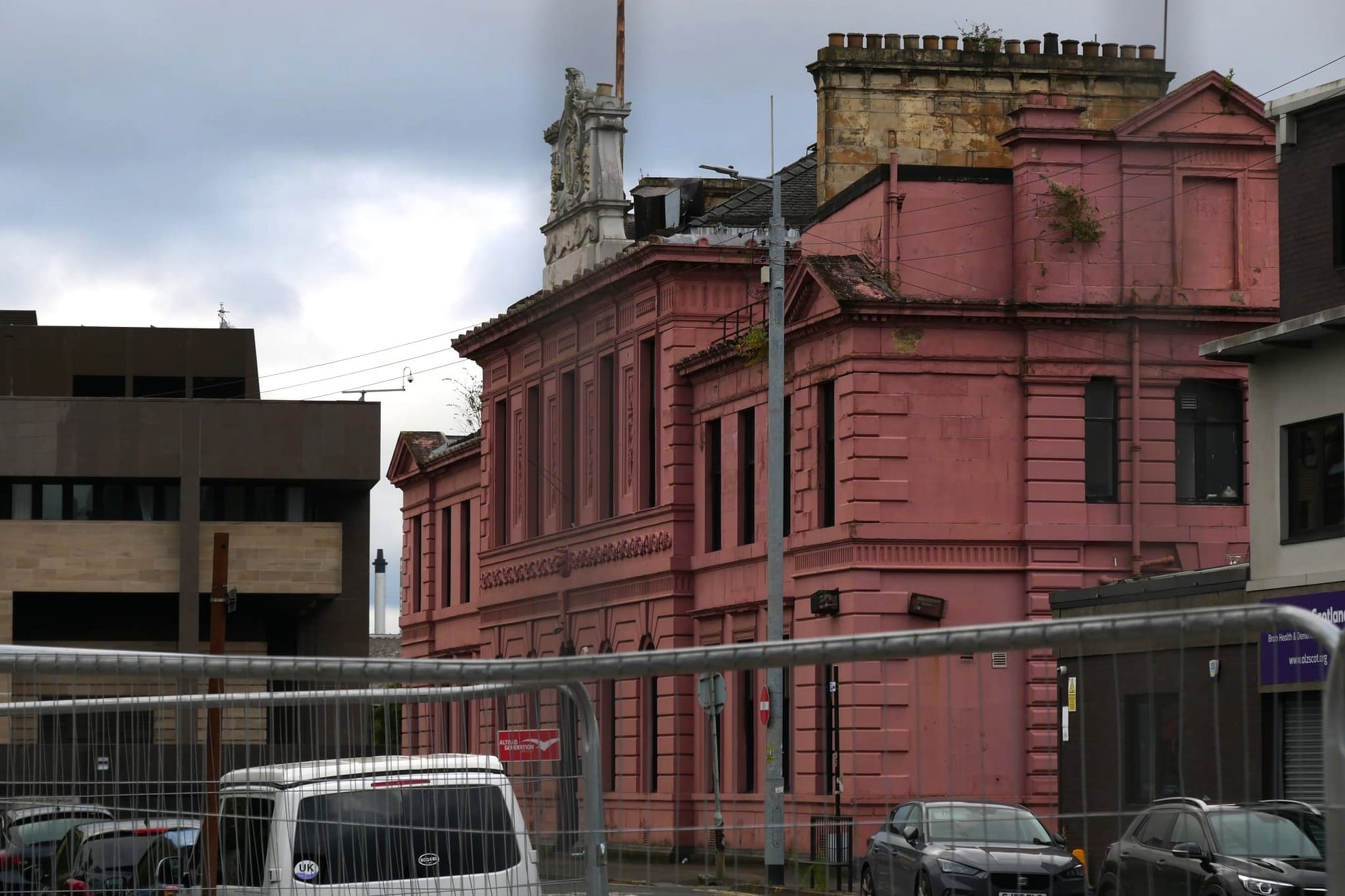 A grand sandstone building that has been painted pink!