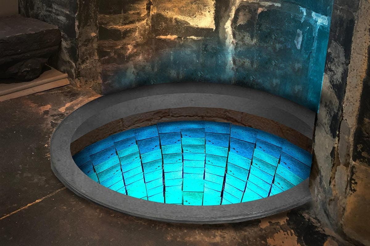 An image of the well with blue mosaic tiles