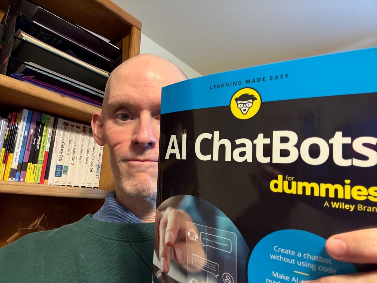 Eric Butow holding a copy of AI ChatBots For Dummies, which he co-authored with Kelly Noble Mirabella.