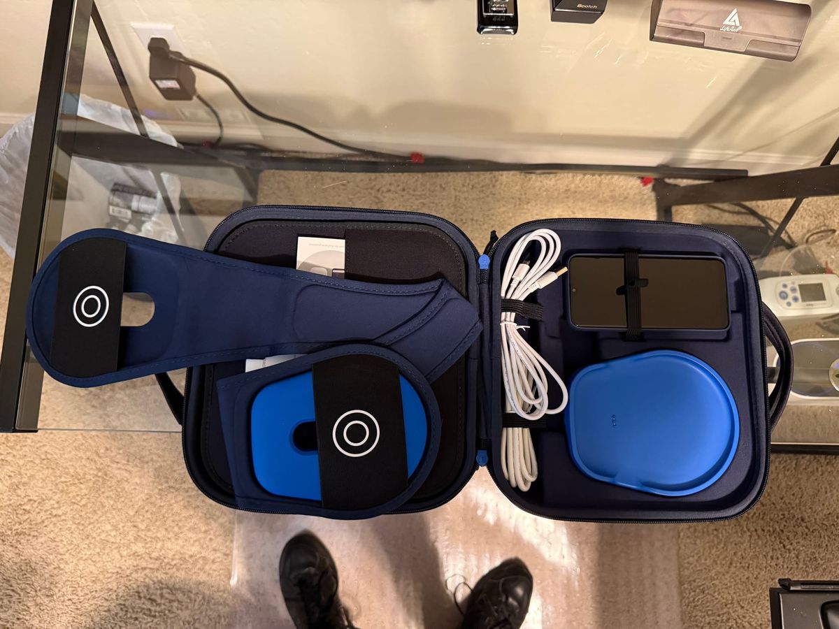 The contents of the large Medtronic bag with the charger, cables, and a Samsung Galaxy phone to help me manage my deep-brain stimulation.