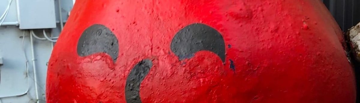 the top half of an 8-foot-tall decaying plaster sculpture of the kool-aid man.