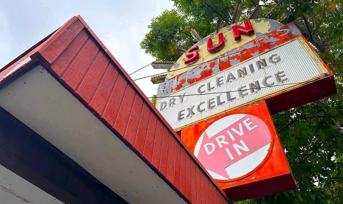 looking upward at the sun dry cleaning sign.