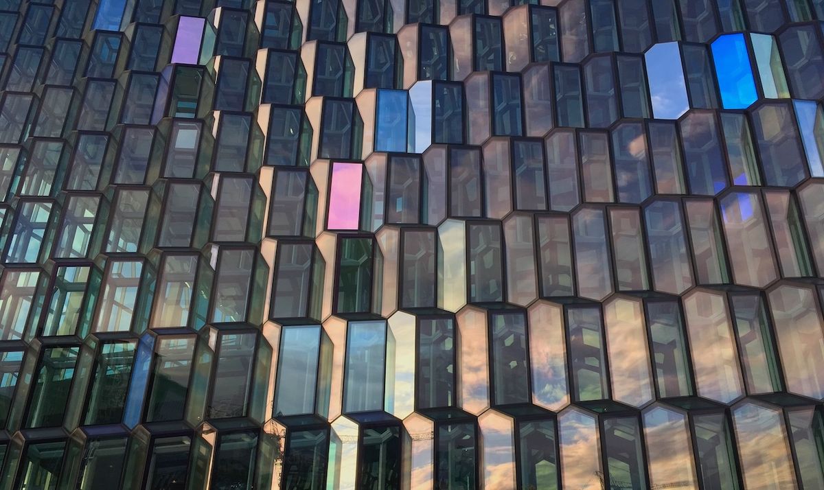 a closeup photo of Harpa, a performing arts center in Reykjavic with a honeycomb-like window design