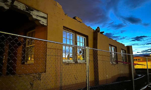 a half-demolished building at dusk near the new mexico state capitol. 