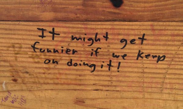 handwritten graffiti in Sharpie on a piece of wood