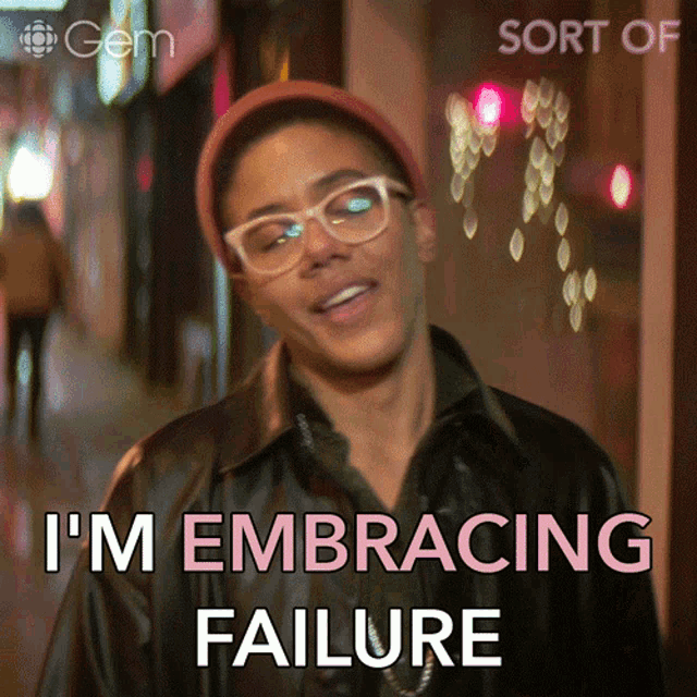 Person in a cap and glasses walking down the street saying "I'm embracing failure"