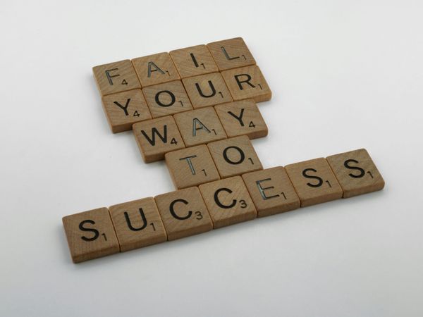 scrabble tiles spelling out Fail Your Way To Success