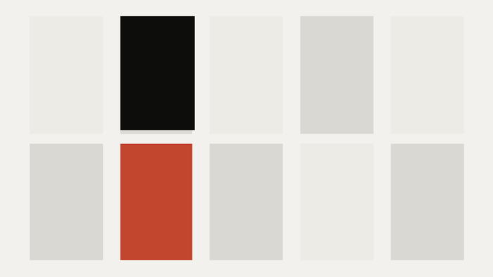 Ten cells, one dominant, one accented, an abstract cut-paper illustration for the article “The 10 AI Strategy Traps That Keep Companies Busy and Stuck”