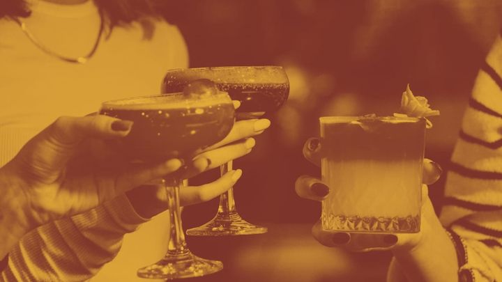 A photo of three cocktails held in women's hands - you can see nail polish and jewelry - a very 80's vibe.