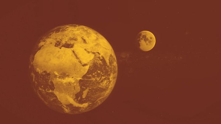 A photo of the earth from space with the moon to the side. The photo has been edited so it's in dark red and yellow instead of the true colors.