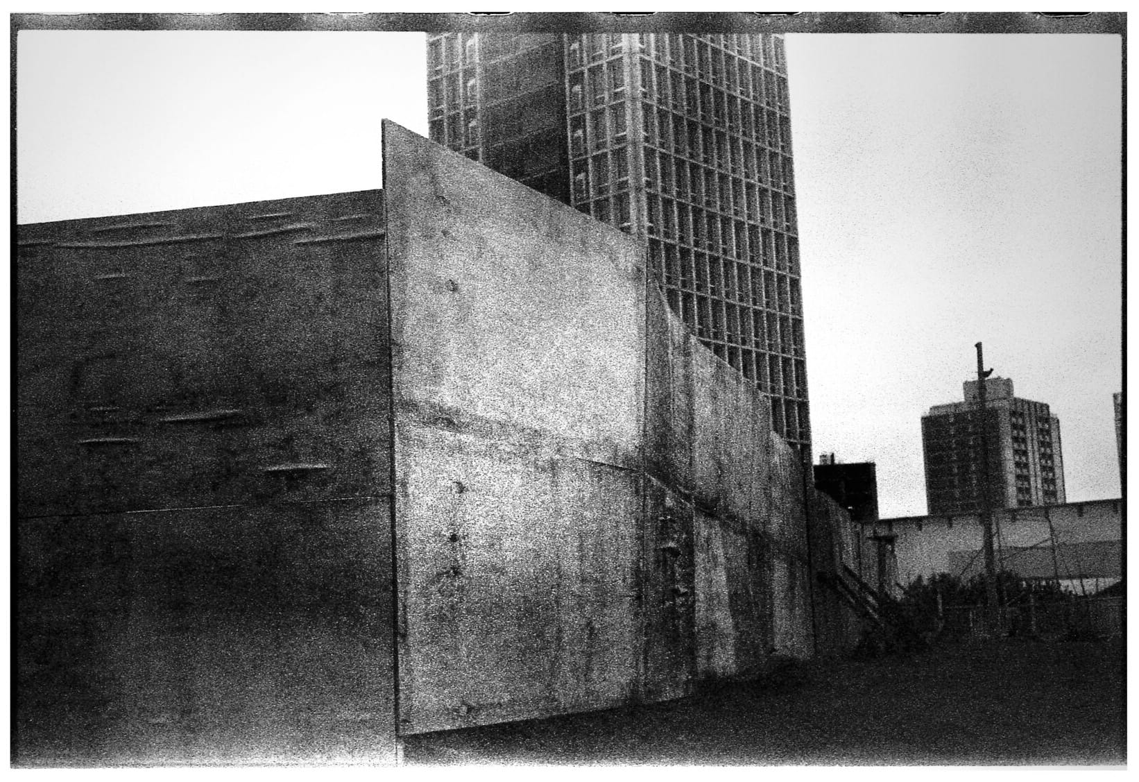 Brutalist building with geometric facade and high contrast.