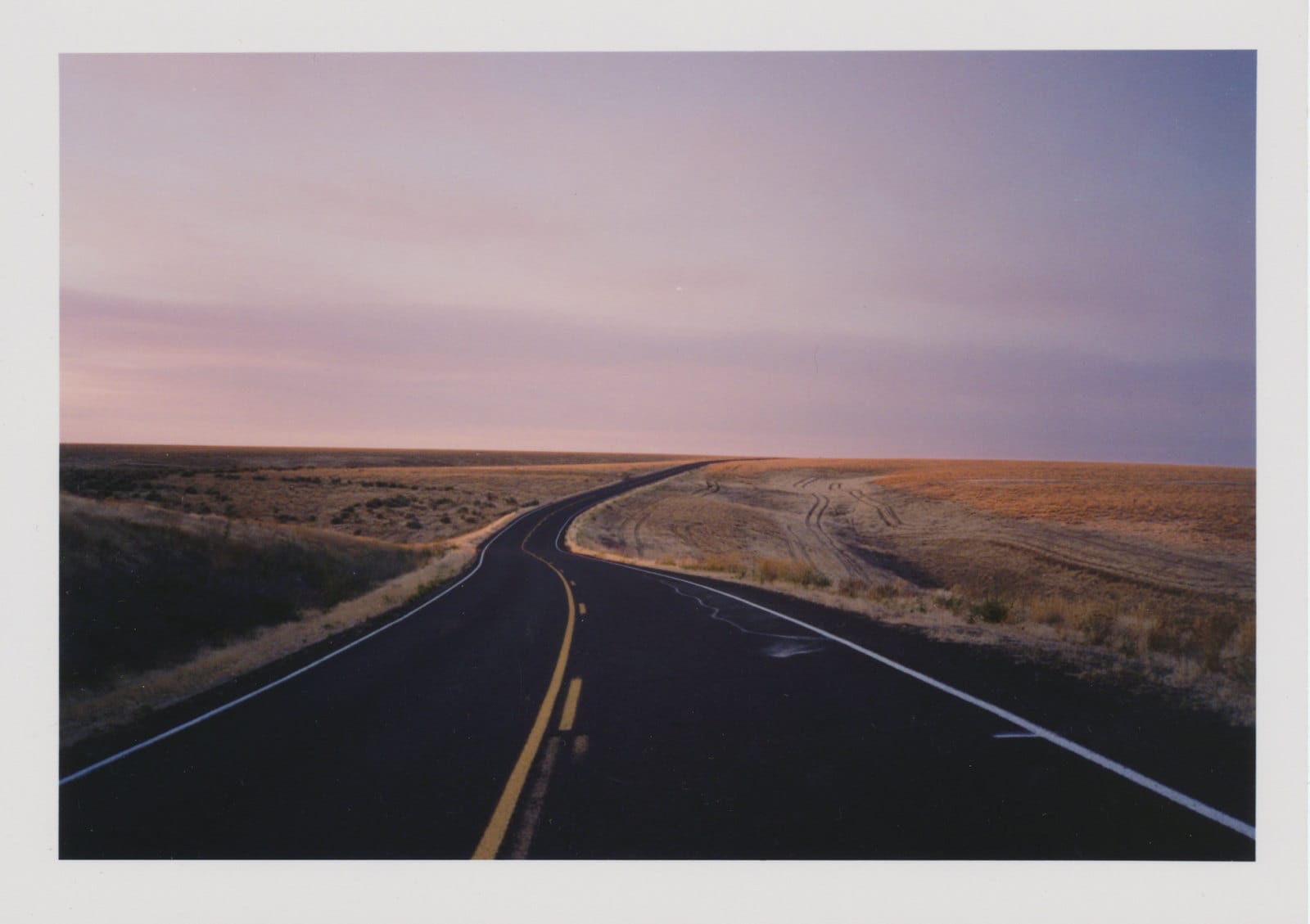 Highway through prairie at dusk.