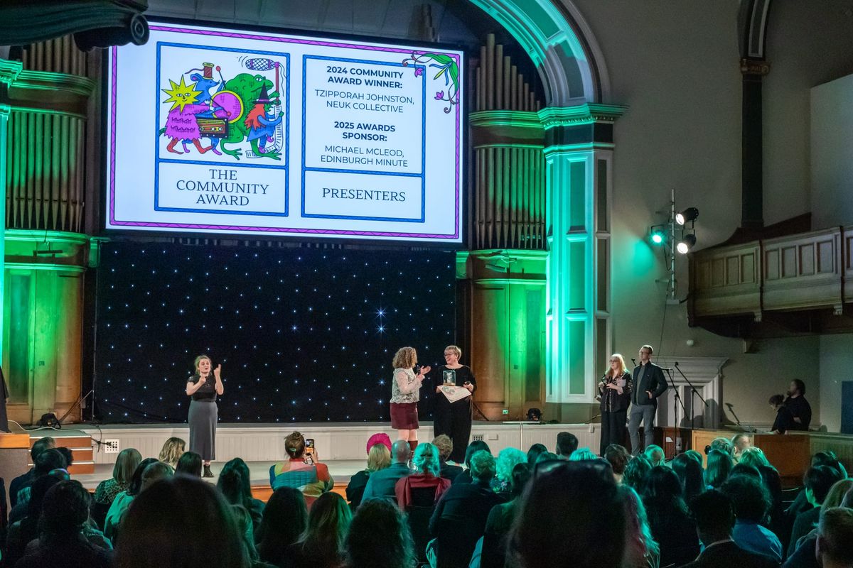People on a stage being given an award. 