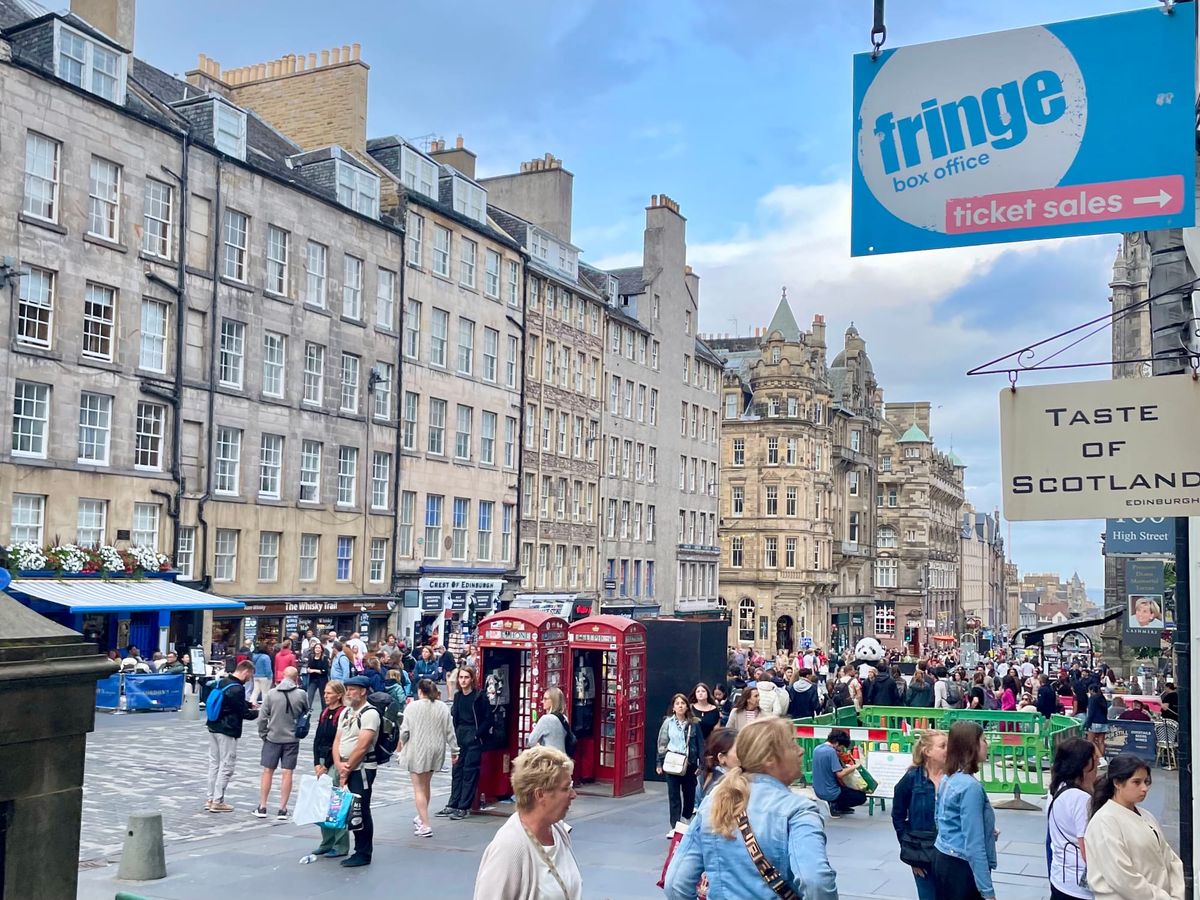People walking in a busy city centre street. 