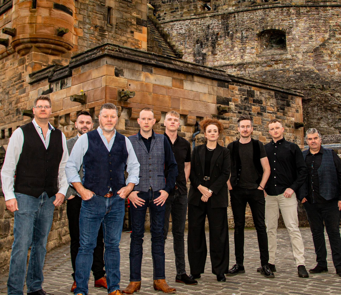 A group of people standing in front of a castle. 