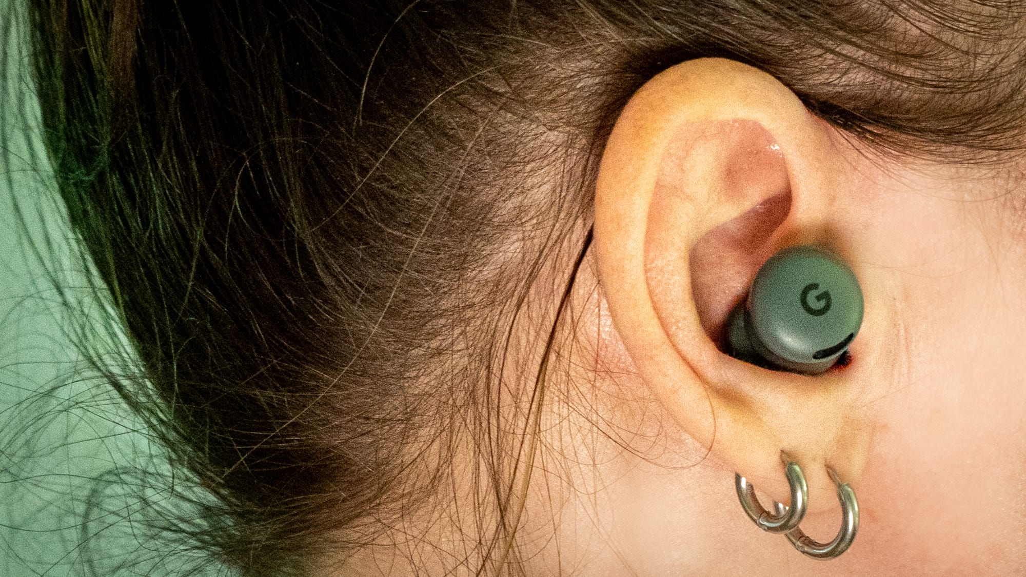 A photo of a person's ear with the earbuds inside.