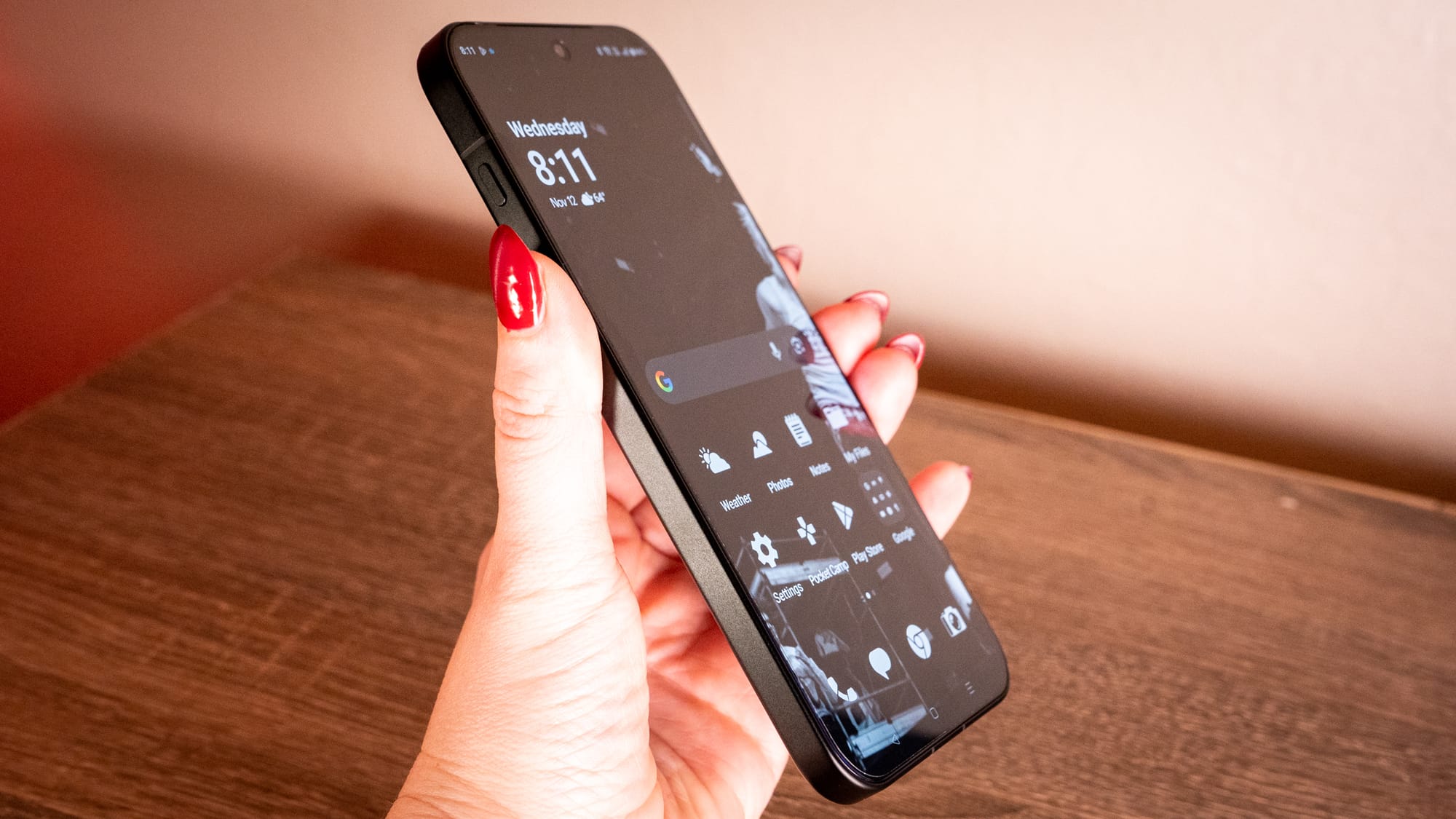 A photo of a hand holding the side of the oneplus 15 that used to have an alert slider