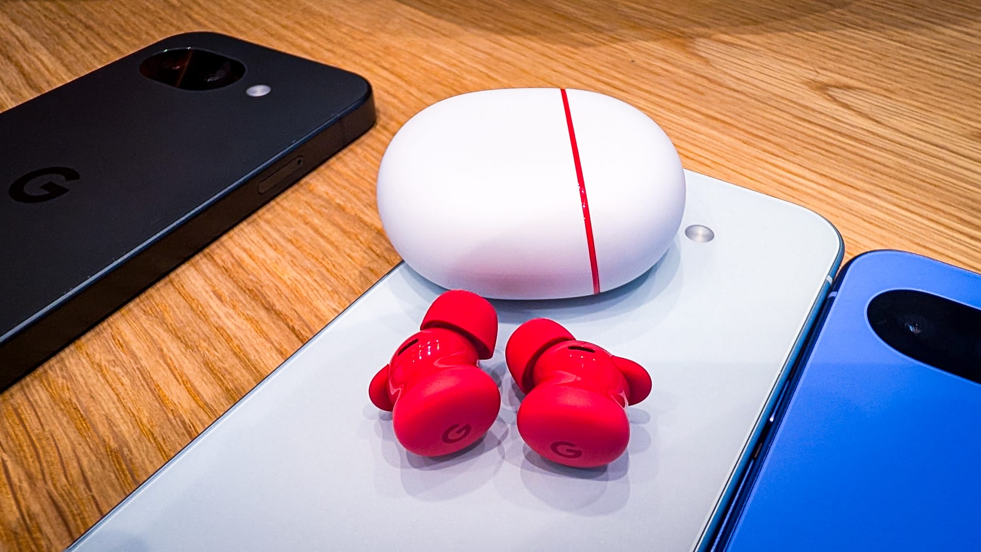 A photo of the Pixel Buds 2a, splayed out on a Pixel device.