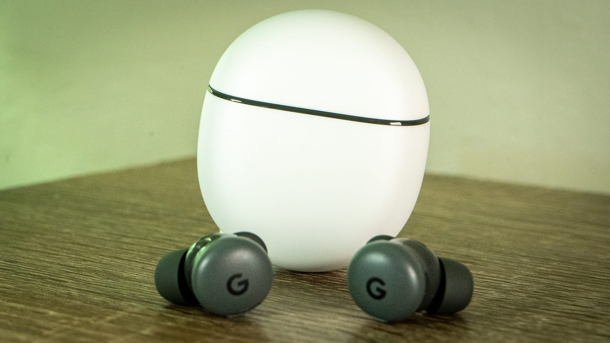 A photo of the Pixel Buds 2a case, upright, and the buds