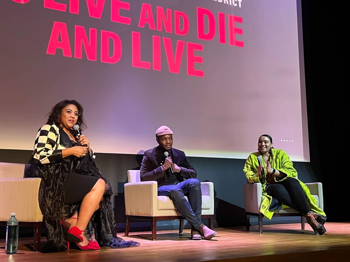 Close-up of the film panel at the Chicago screening of “To Live and Die and Live,” with cast and creatives in conversation on stage.